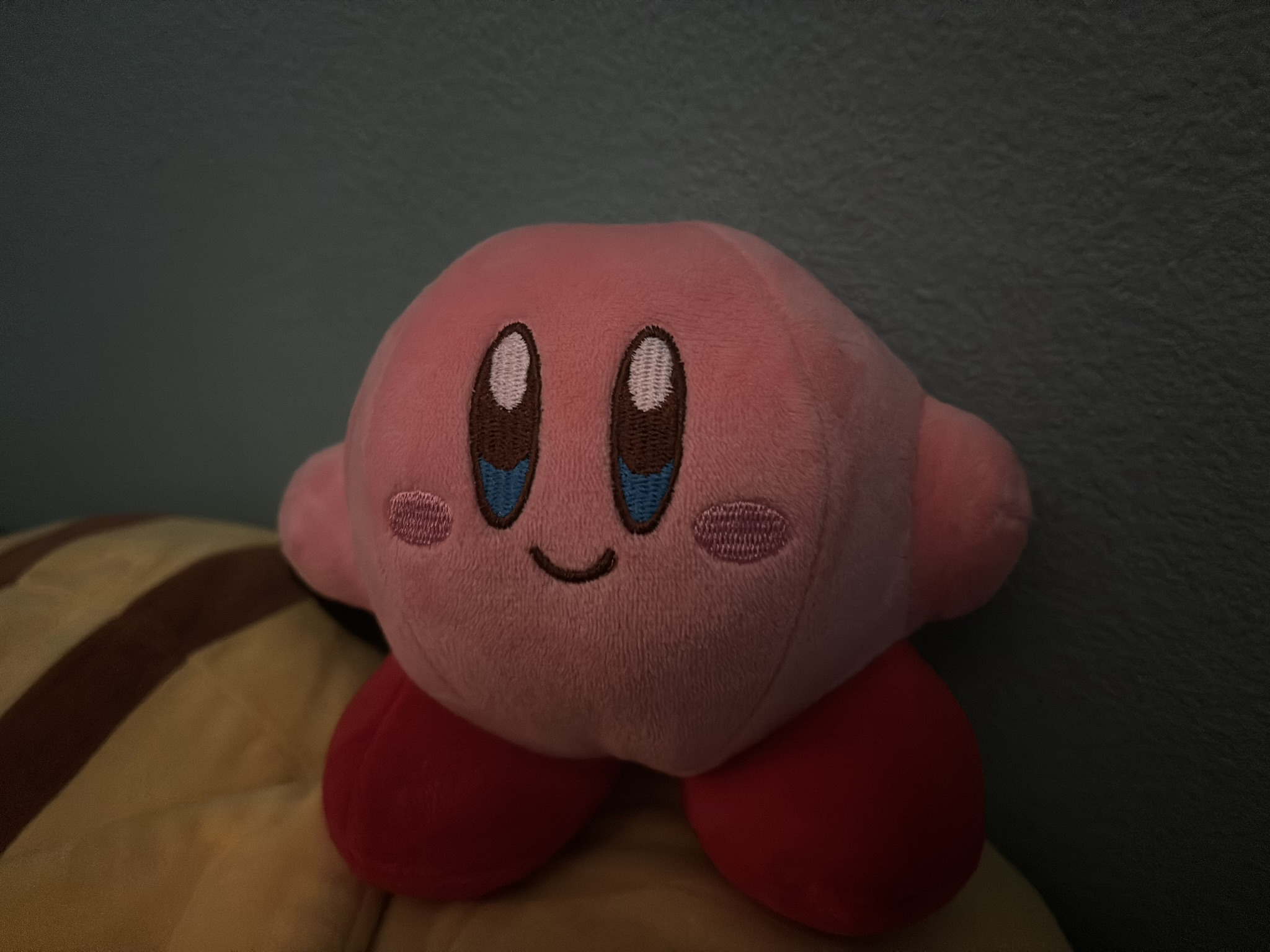 My Kirby plush on top of my sleeping Pikachu plush.